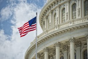 Dome of the Washington Capitol with the American flag flying