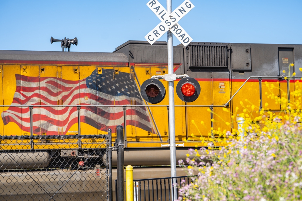 american railroad crossing signal and train