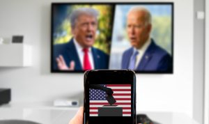 Biden and Trump on TV in blurred background