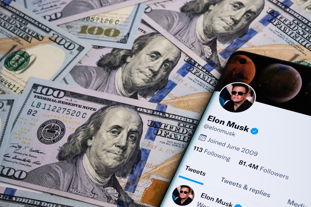 Elon,Musk's,Twitter,Account,Page,On,The,Smartphone,and,dollars