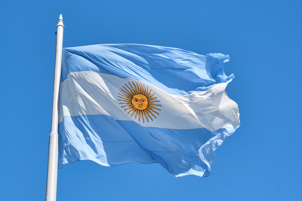 Argentine,Flag,Flying,On,A,Flagpole,Against,A,Blue,Sky